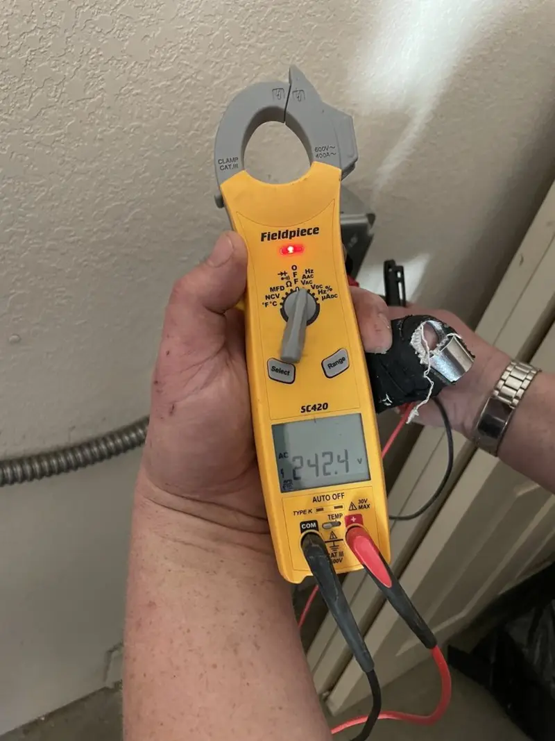 Voltage testing with clamp meter during Recessed Lighting Installation in Flower Mound